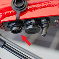 The relay board on the Optibike, the arrow points to the charge connector